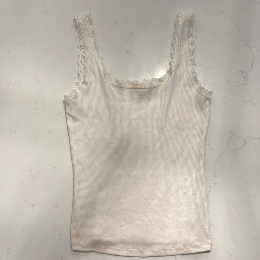White lace trim form fitting mid length tank top—